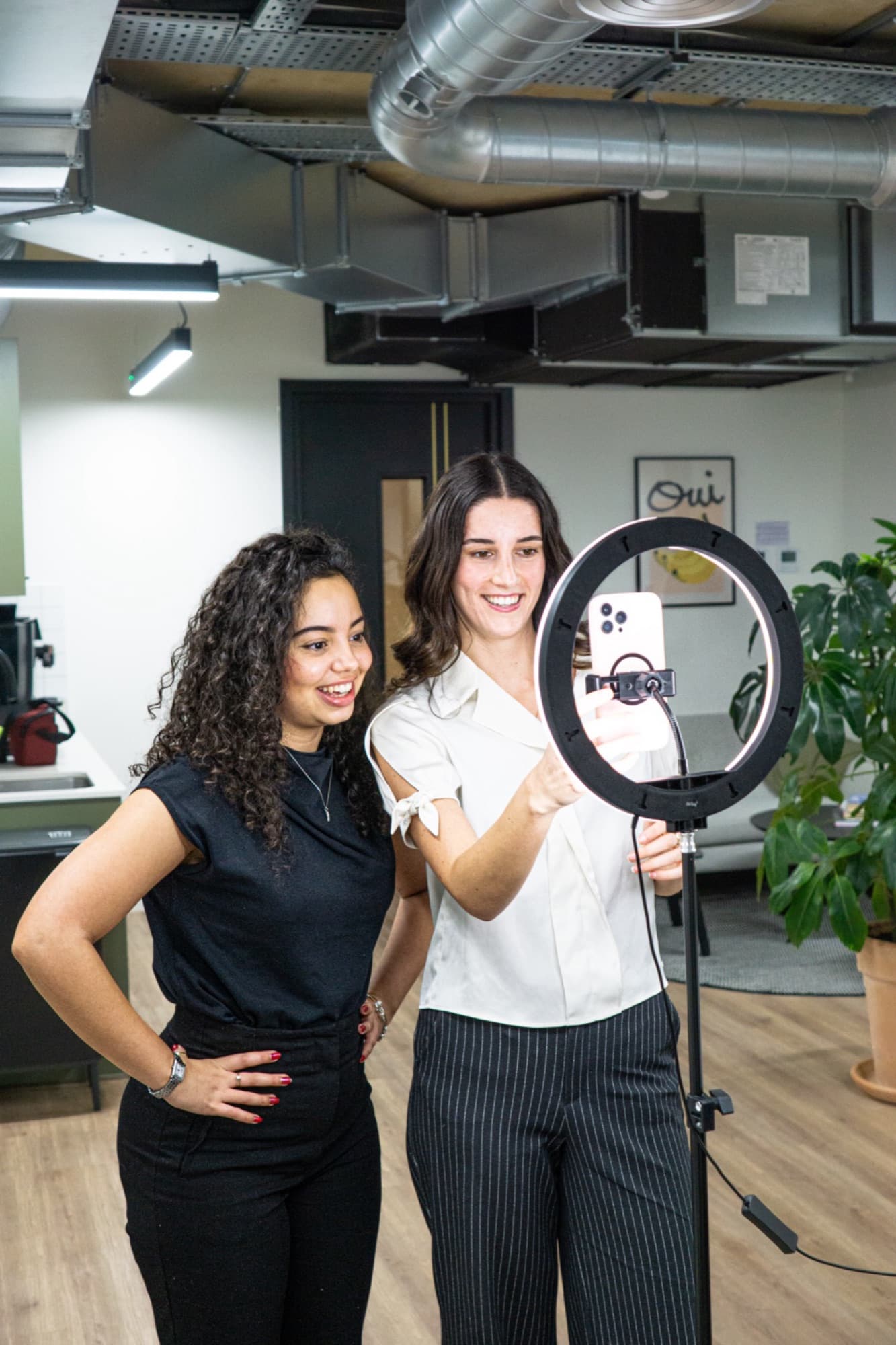 Two GoPlaces presenters preparing a livestream with a ring light