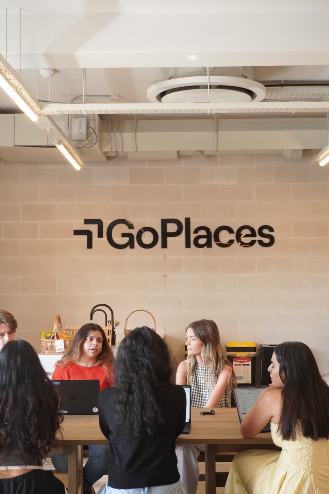 GoPlaces team planning together at laptops in the office